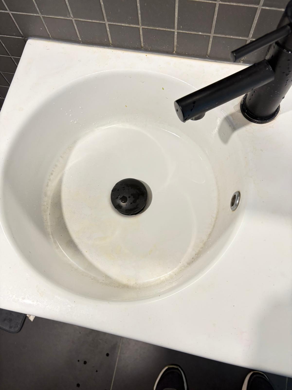 Visible soap scum, mineral deposits, and grime buildup had left the basin looking dull and unhygienic.
